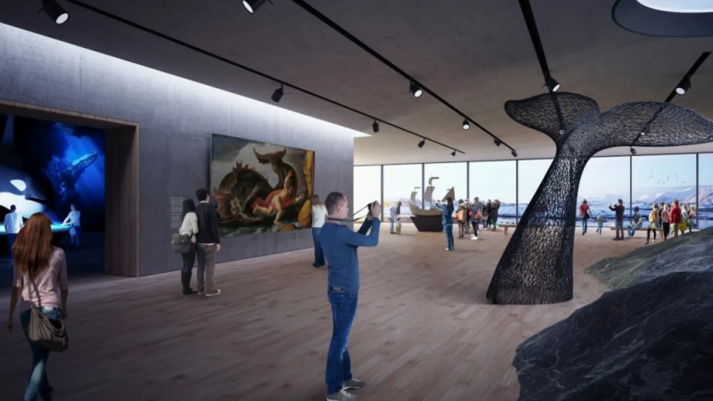 Spacious museum gallery with visitors, large black whale-tail sculpture, paintings on walls, and ocean view windows.