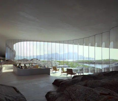 Modern interior lounge with curved floor-to-ceiling glass wall, chairs and tables, overlooking rocky landscape and water.