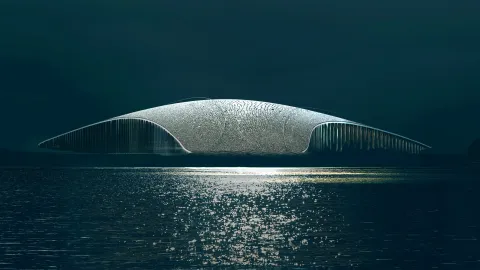 A low, futuristic dome-like structure sits above calm dark water, with a bright reflection shimmering in the foreground.