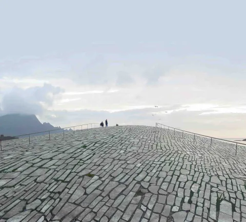 Wide view of a stone-paved hill with railings, a few people near the crest, and a cloudy sky above.